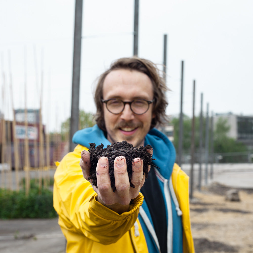 Enno im Kackewald mit einem Haufen Erde in der Hand